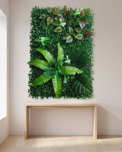 One artificial plant wall panel mounted on an interior wall above a pale oak console
