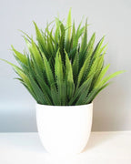 Mini artificial potted plant, grass foliage in a matte white pot