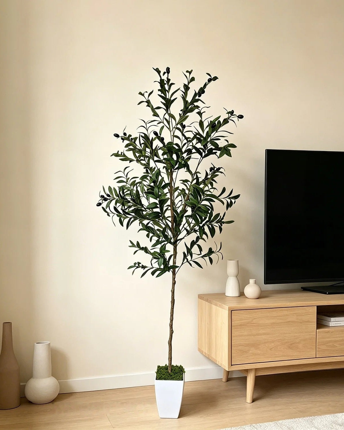 Artificial olive tree beside a light oak TV console (planter not included)