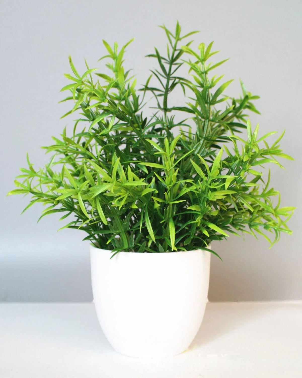 Mini artificial potted plant, rosemary foliage in a matte white pot