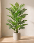 Artificial areca palm in a plain stone pot on an oak floor in soft daylight (pot not included)