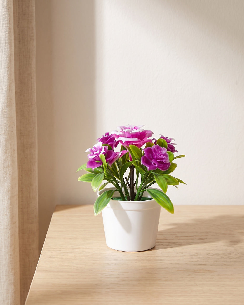 The 5.5 in flowering pot version, shown in purple, on a pale oak tabletop