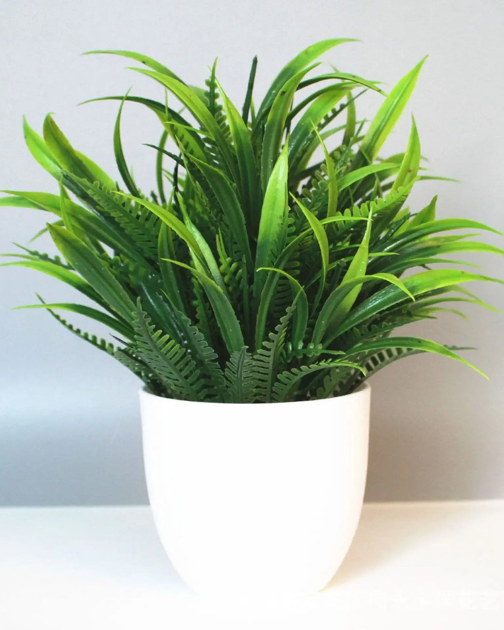 Mini artificial potted plant, fern foliage in a matte white pot
