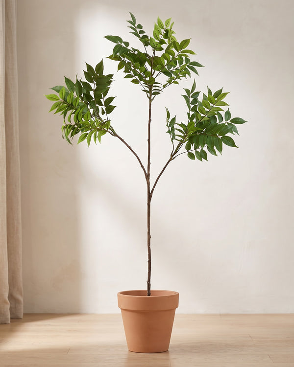 Artificial ficus branch with three side branches, standing in a plain terracotta pot on a pale oak floor (pot not included).