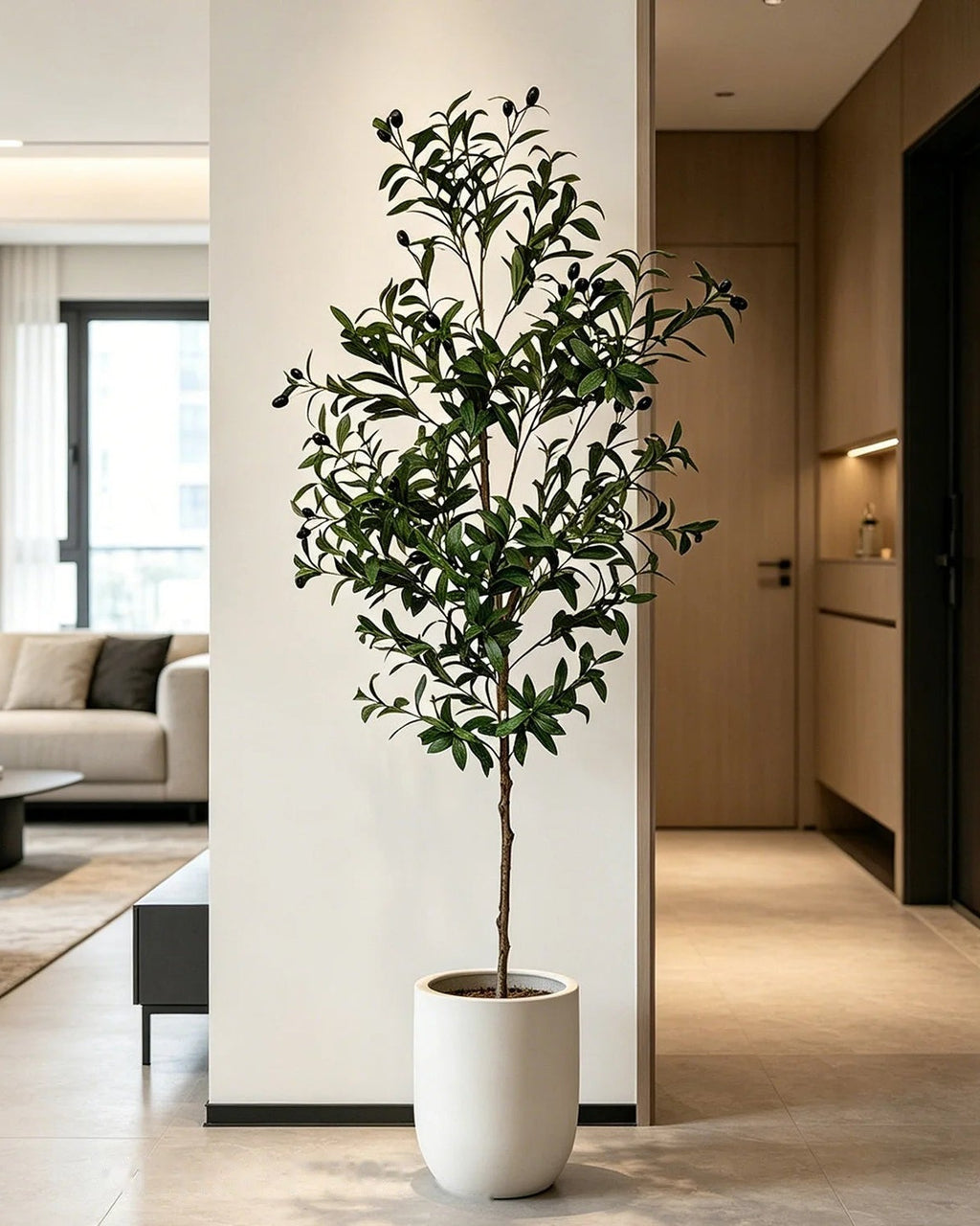 Artificial olive tree in a white pot in a modern hallway (planter not included)