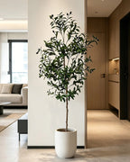 Artificial olive tree in a white pot in a modern hallway (planter not included)