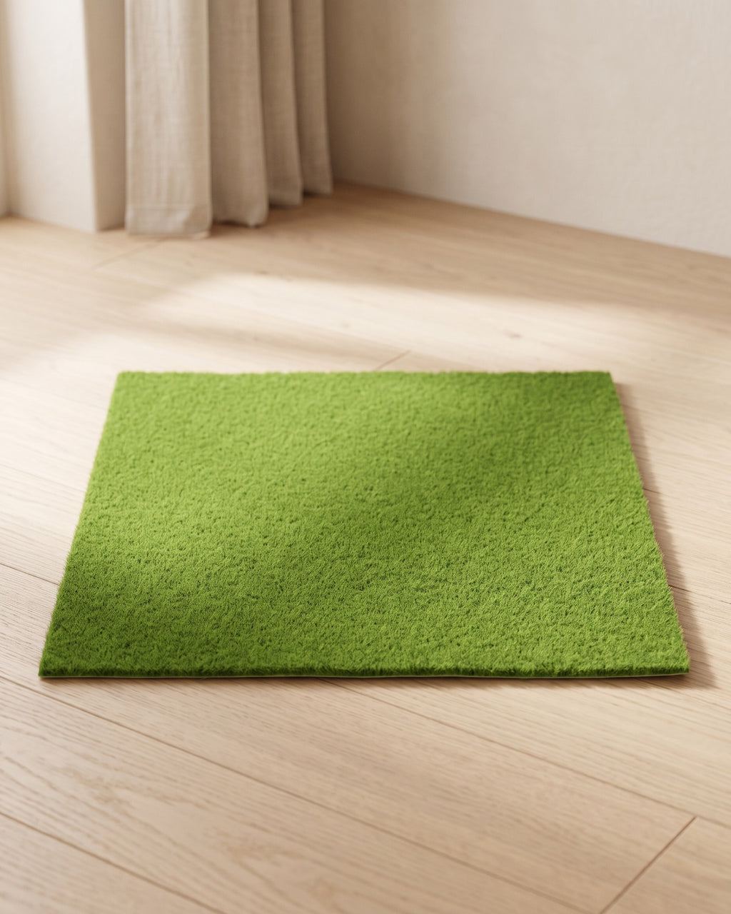An artificial grass mat laid flat on pale oak floorboards in a bright, calm room