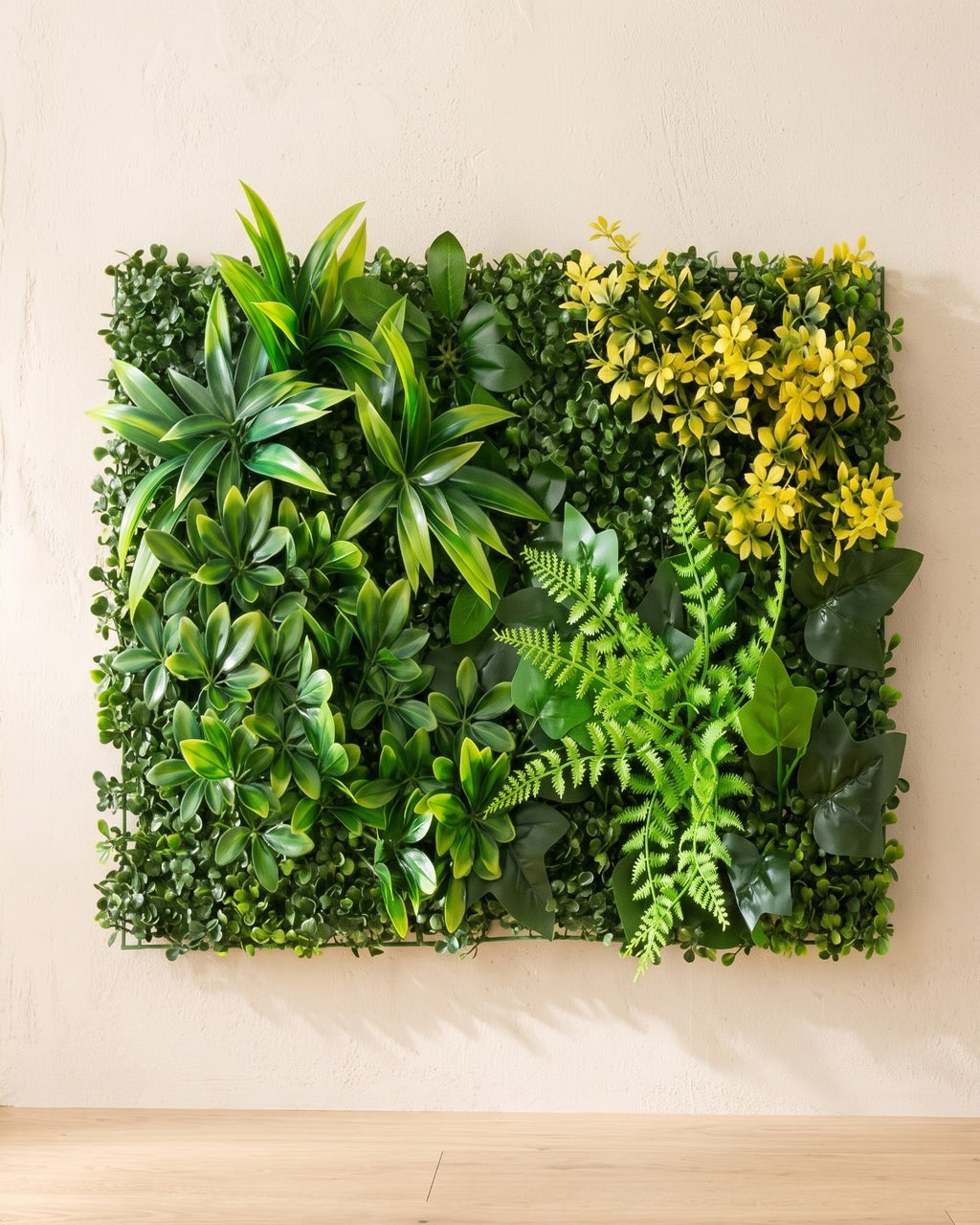 Green blades and yellow bloom artificial green wall panel fixed flat on an off-white plaster wall
