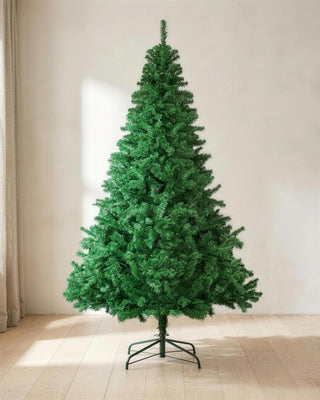 A green artificial spruce Christmas tree, undecorated, on its stand in a bright room
