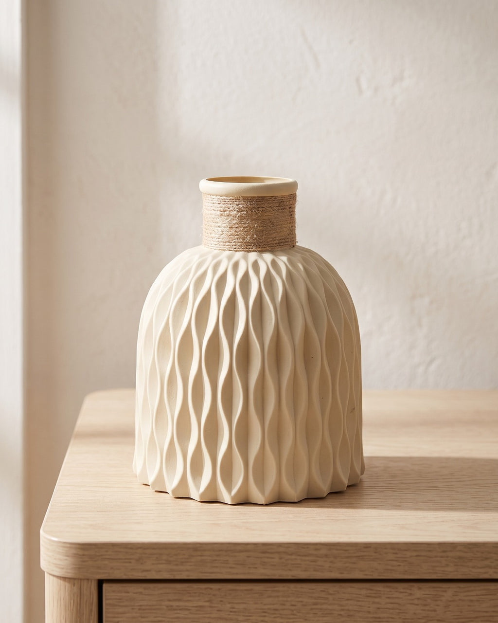 Beige rope neck vase, empty on a pale oak table