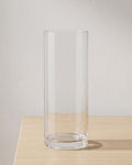 Clear acrylic cylinder vase, size S, empty on a pale oak table
