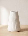 Fluted tapered vase, size S, empty on a pale oak table