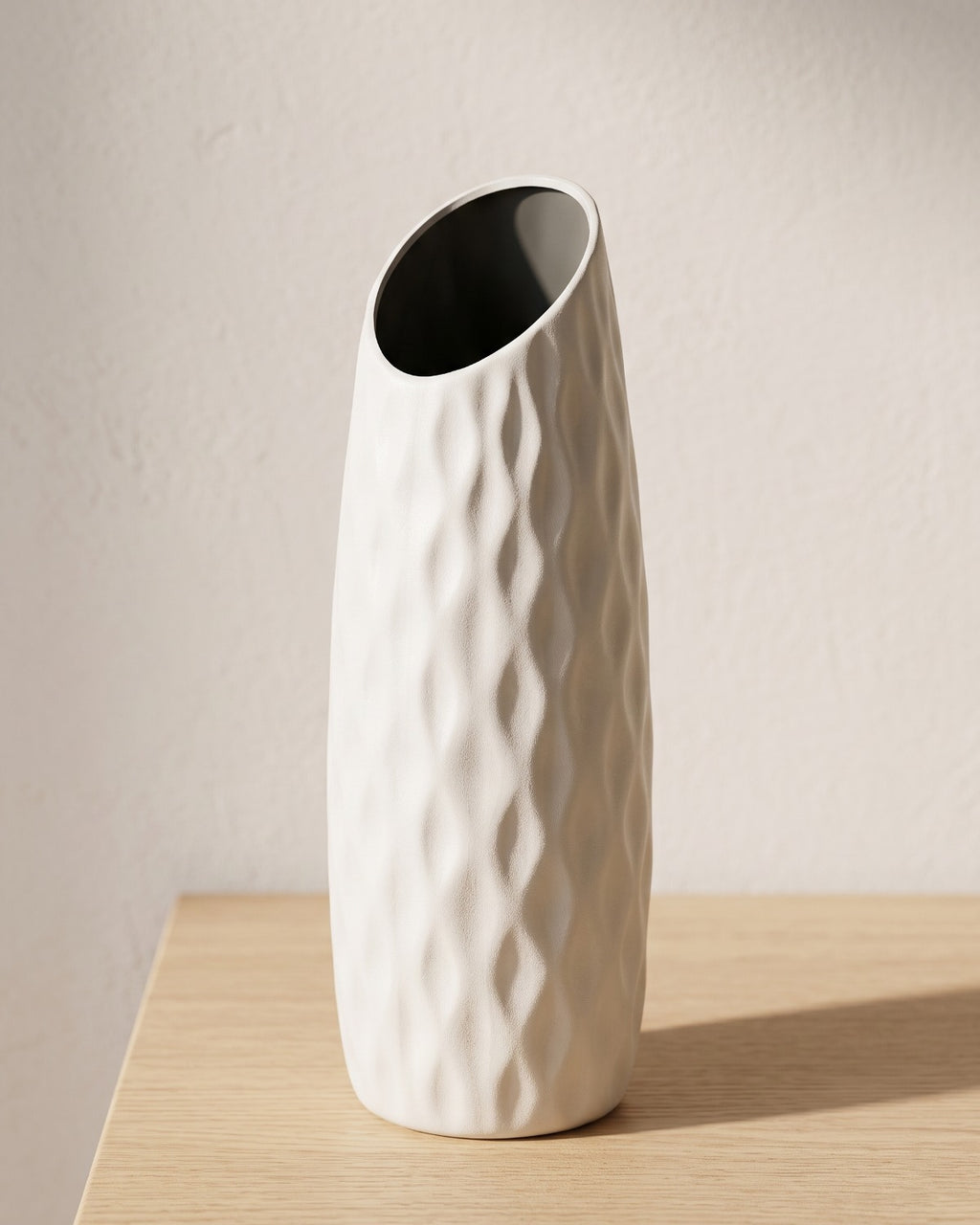 Quilted origami vase, 8.3 in, empty on a pale oak table
