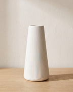 Fluted tapered vase, size M, empty on a pale oak table