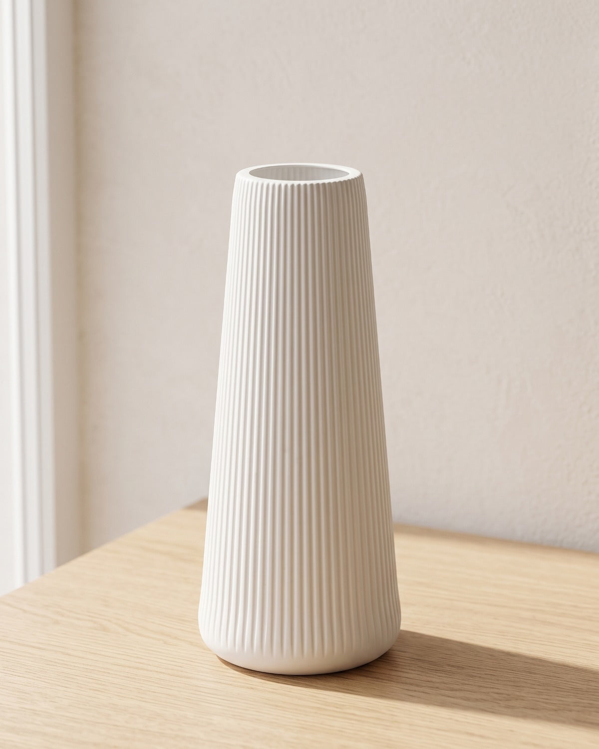 Fluted tapered vase, size L, empty on a pale oak table