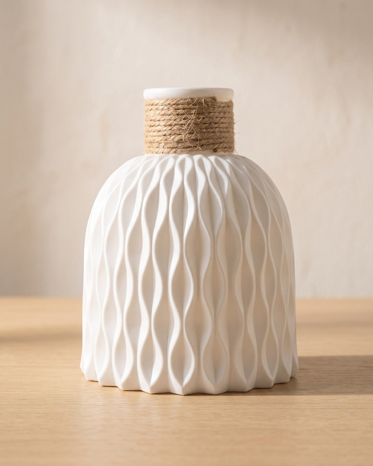 White rope neck vase, empty on a pale oak table