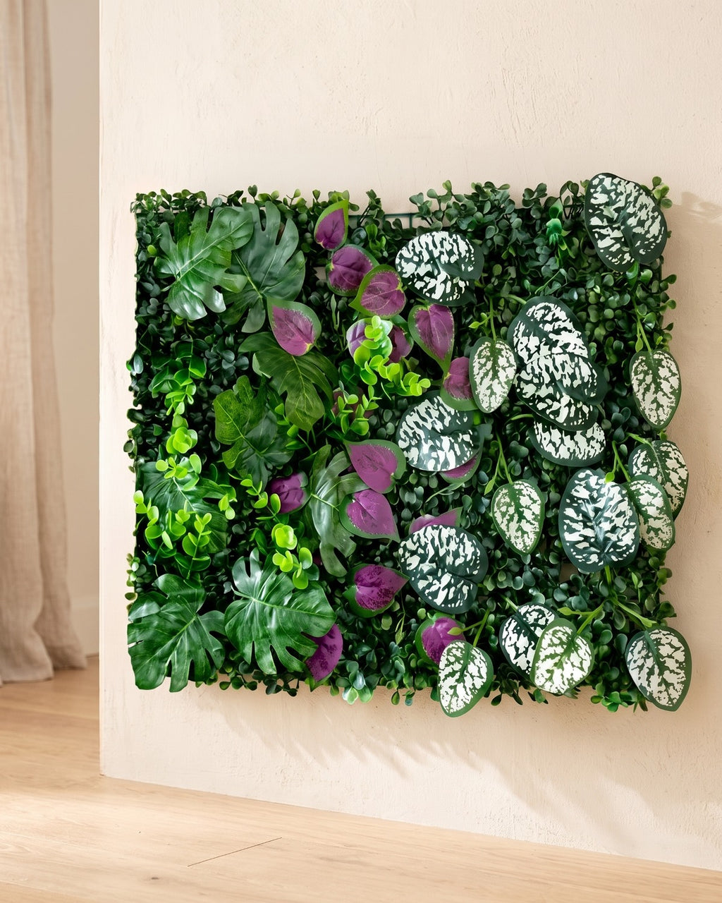 Purple and white spotted leaf artificial green wall panel fixed flat on an off-white plaster wall