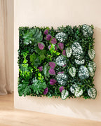 Purple and white spotted leaf artificial green wall panel fixed flat on an off-white plaster wall