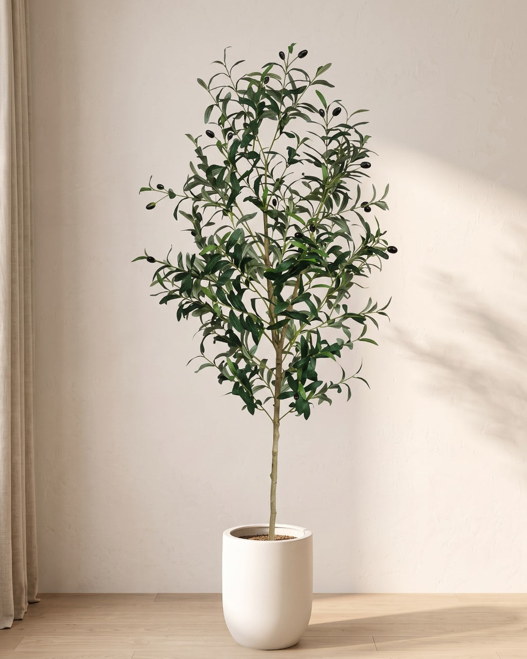 The 63 in artificial olive tree standing in a plain white pot on an oak floor; planter not included