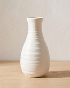 Ribbed bottle origami vase, 8.1 in, empty on a pale oak table