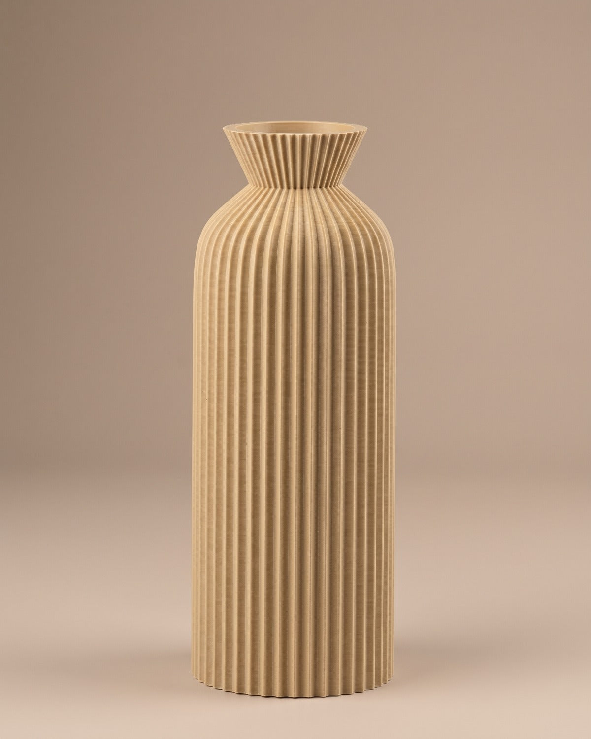 Khaki ribbed bottle vase, large, empty on a pale oak table