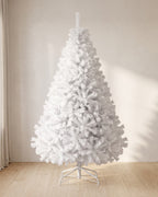 White artificial Christmas tree, undecorated, on its white folding stand