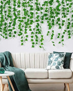 Artificial ivy garland trailing down a living-room wall behind a pale sofa
