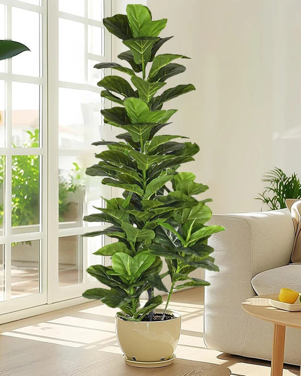 Artificial fiddle leaf fig tree in a cream pot in a sunlit living room