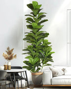 Artificial fiddle leaf fig tree in a gray pot behind a dining chair in a white room