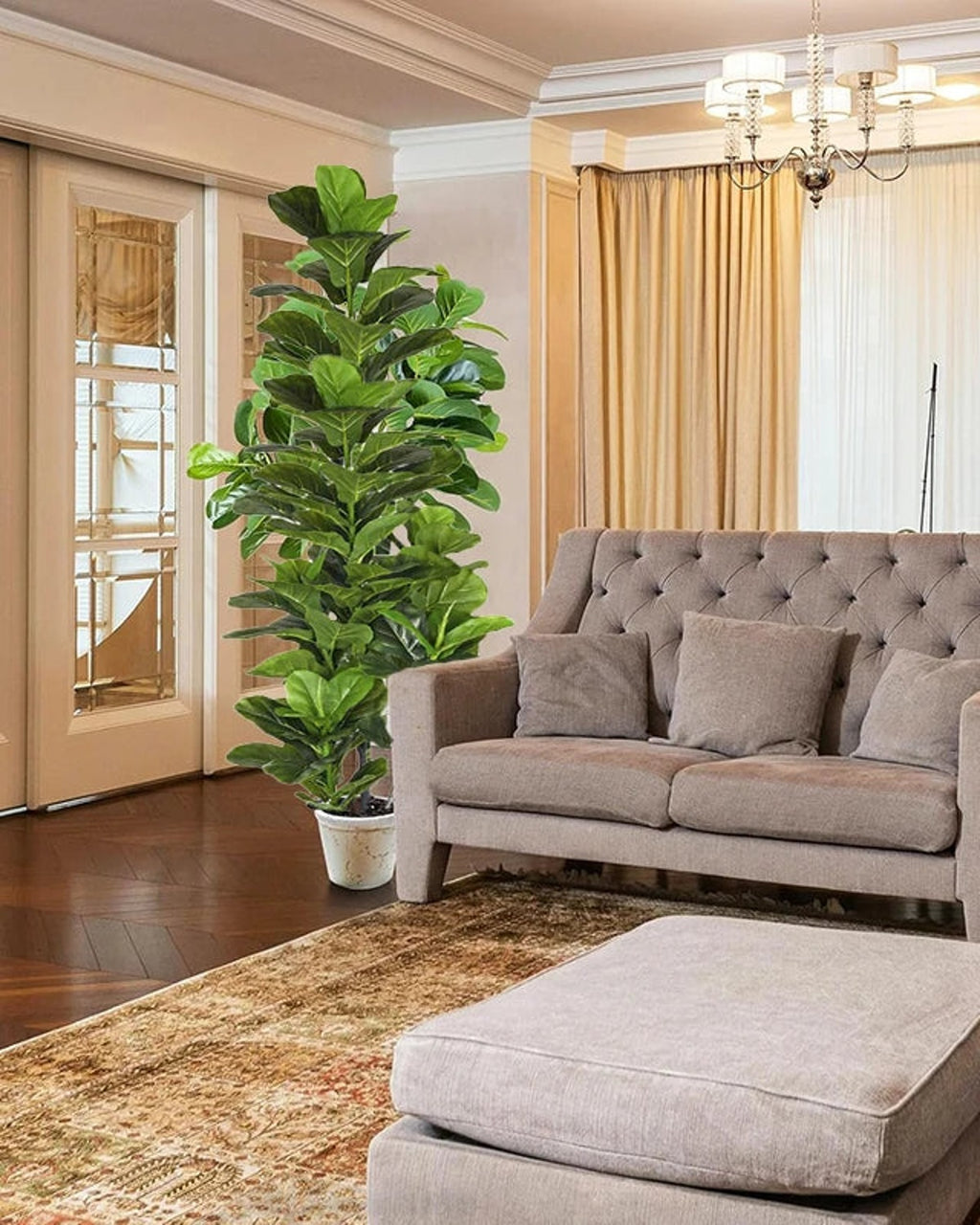 Artificial fiddle leaf fig tree in a white pot in the corner of a living room with a gray sofa