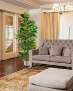 Artificial fiddle leaf fig tree in a white pot in the corner of a living room with a gray sofa