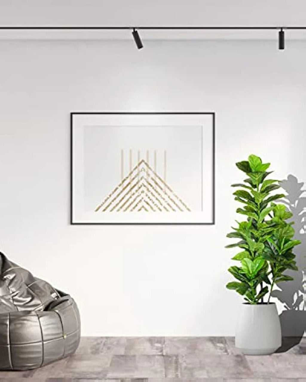 Artificial fiddle leaf fig tree in a white pot beside a framed print and a bean bag