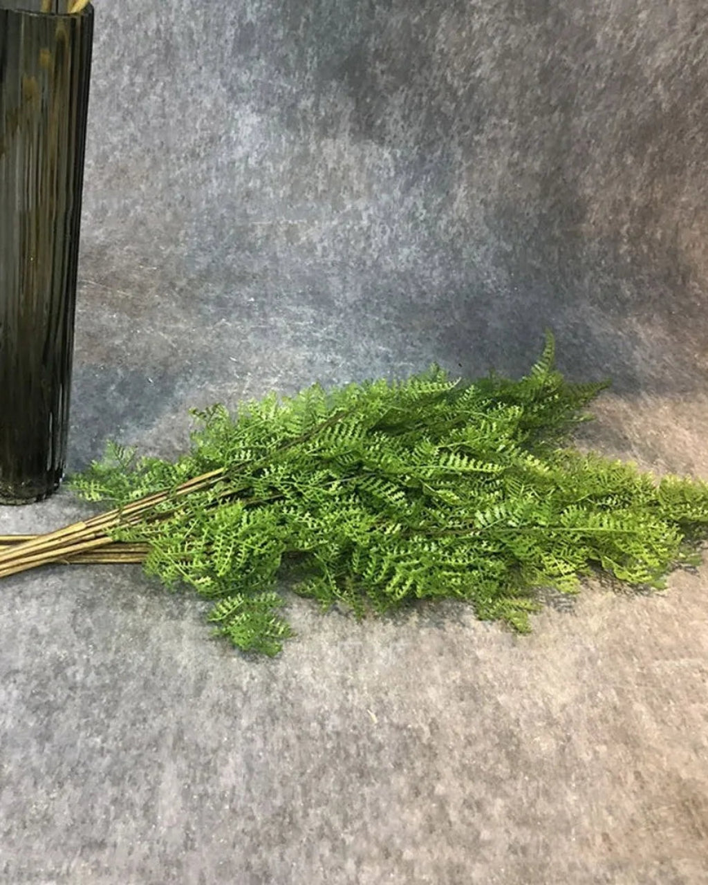 Artificial fern branches lying in a bunch
