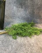 Artificial fern branches lying in a bunch