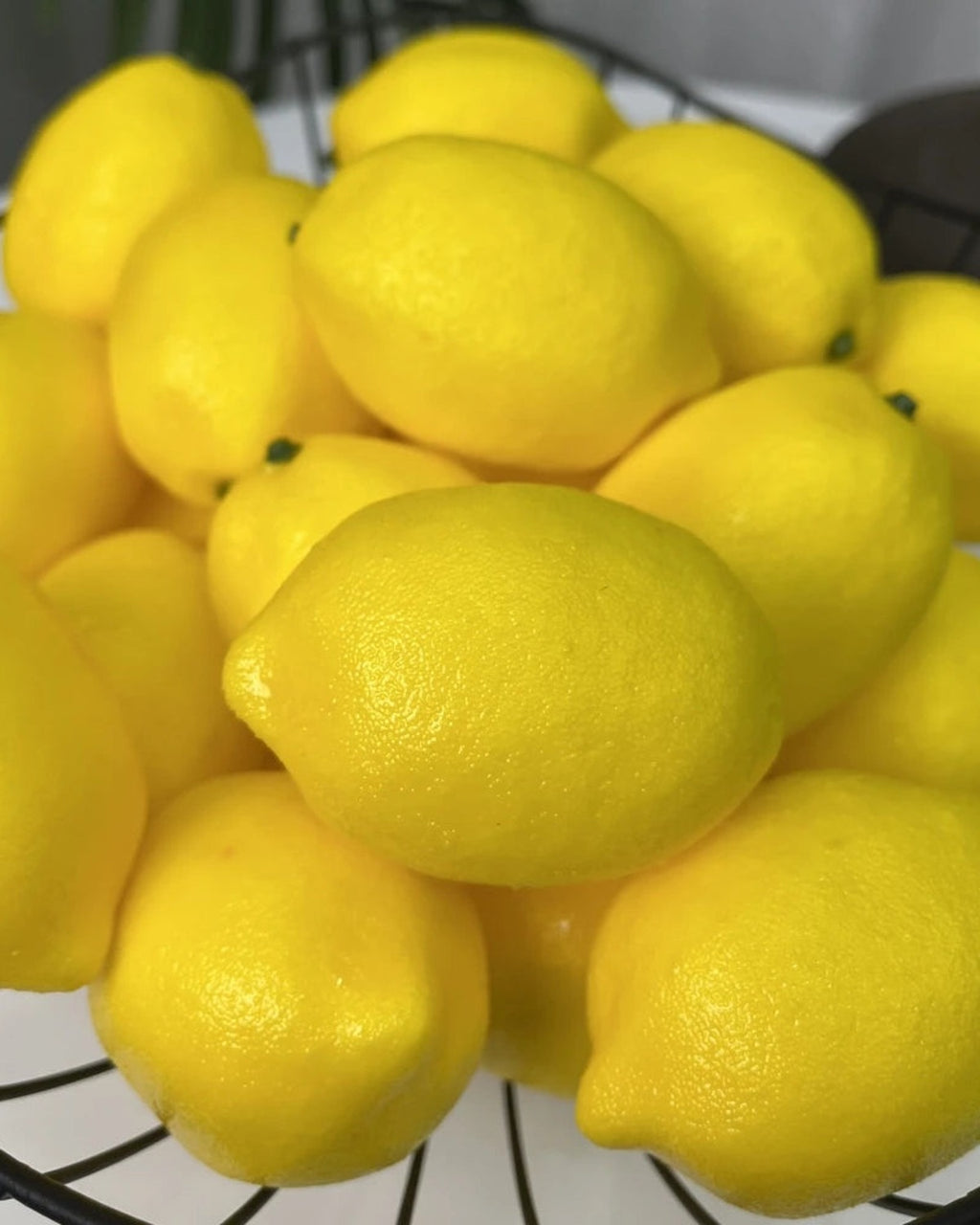 Artificial lemons in close view, showing the pitted skin and the slight neck