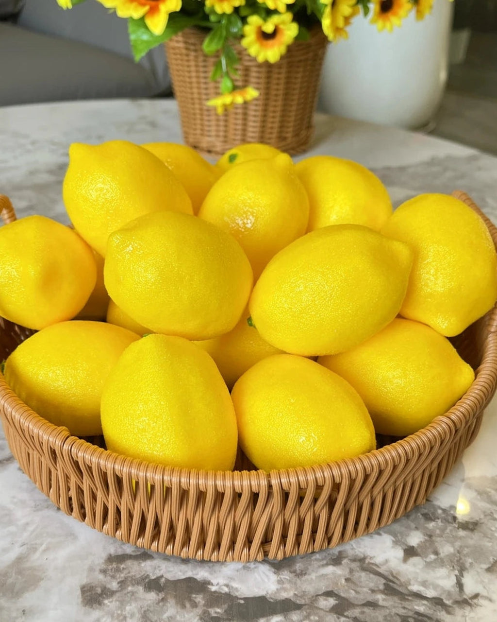 Artificial lemons filling a round woven basket