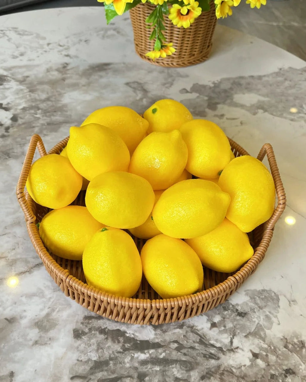 Artificial lemons in a woven basket on a marble counter