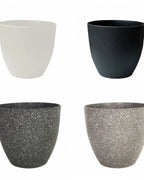 The four colors of the stone effect plant pot side by side: stone, charcoal, white and black