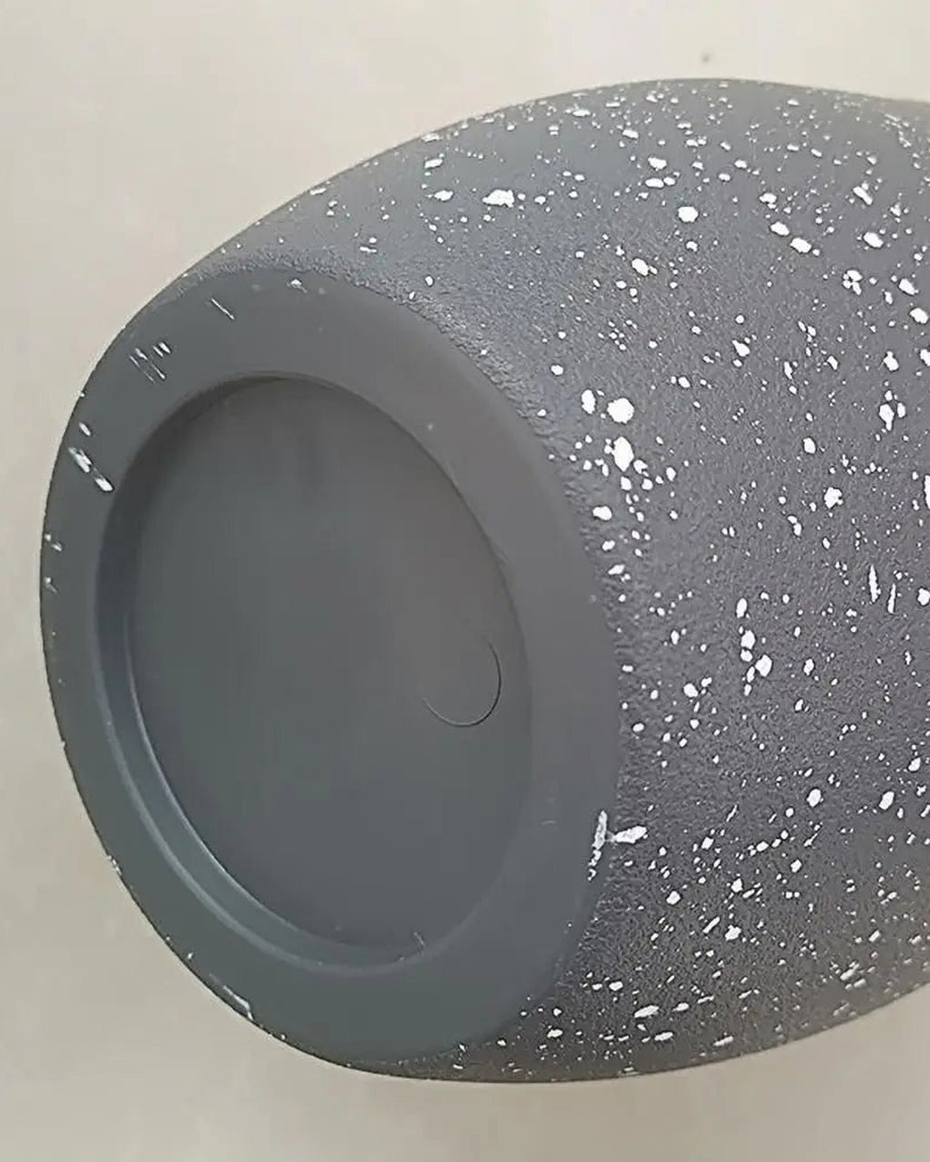 The base of the stone effect plant pot, showing the recessed drainage