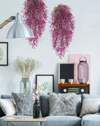 Magenta artificial wisteria sprays hung on a living room wall; each order is one spray