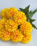 Golden yellow artificial pompom chrysanthemums, the ball shaped blooms in close view