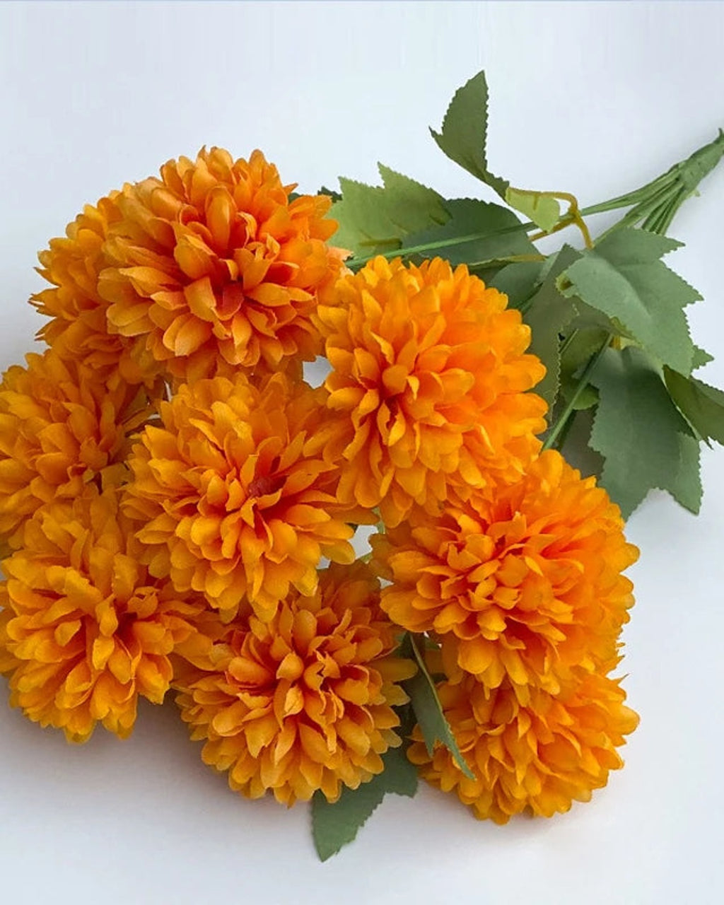 Orange artificial pompom chrysanthemums, one bunch