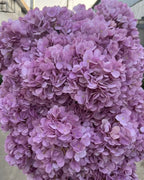 Light purple artificial hydrangea flowers filling the frame, the small florets in close view