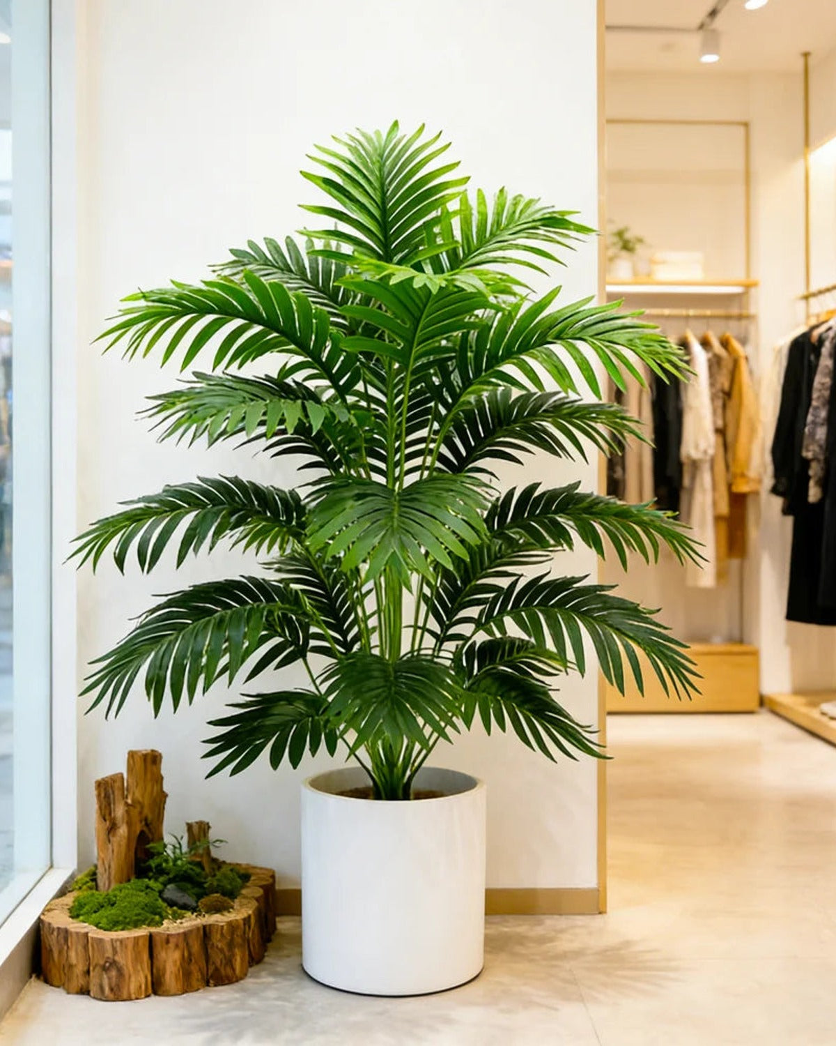 An artificial palm leaf bush in a shop doorway; pot not included