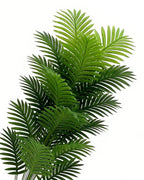 The fronds of the artificial palm leaf bush on a plain background, each cut into narrow finger-like segments