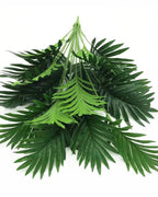 The artificial palm leaf bush laid flat on a plain background, showing all its fronds and the bound base