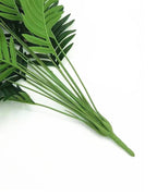 The bound base of the artificial palm leaf bush, where the stems gather