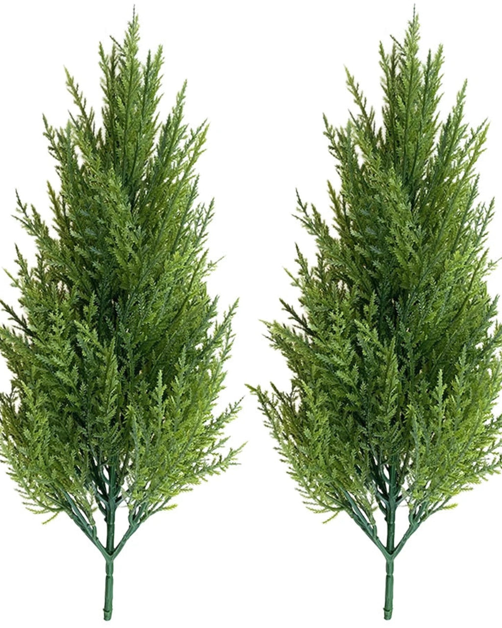 Two artificial pine trees without pots, side by side