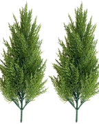 Two artificial pine trees without pots, side by side
