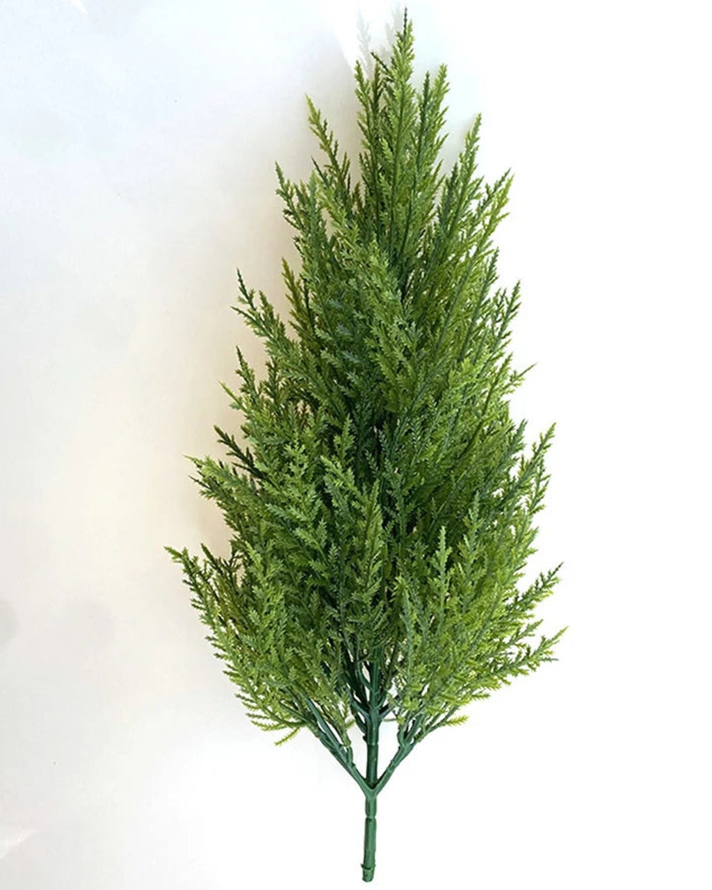 A single artificial pine tree without a pot, showing its conical shape and the bare trunk below the needles